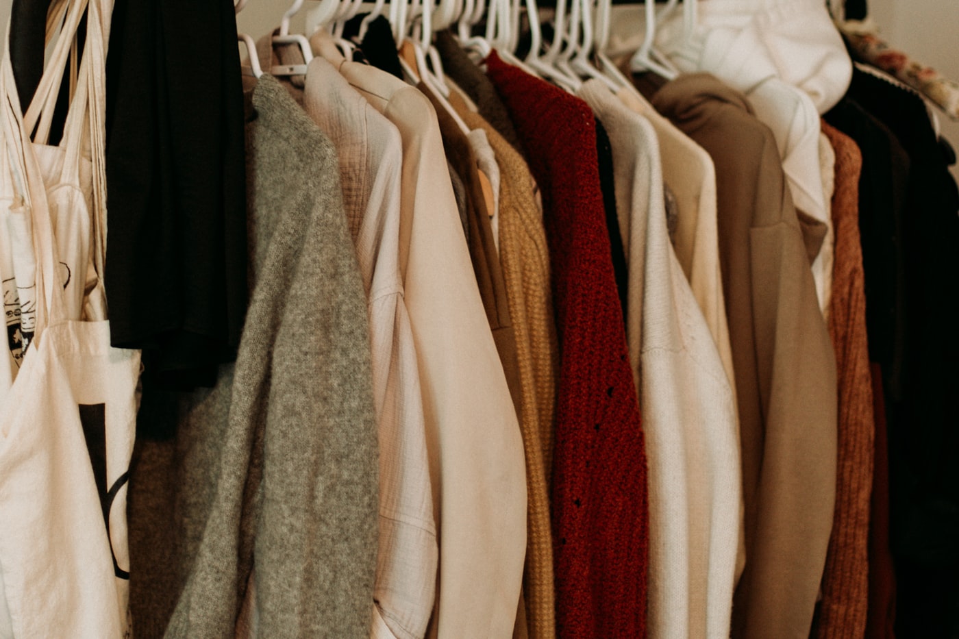 Organized closet with garments in neutral tones