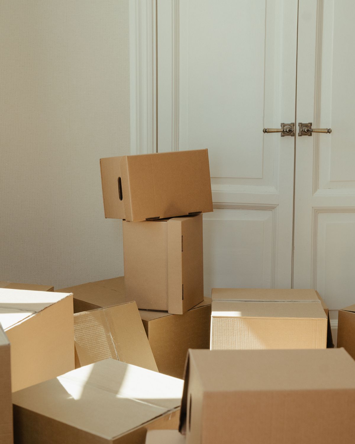 Cardboard moving boxes waiting to be unpacked in a bright home